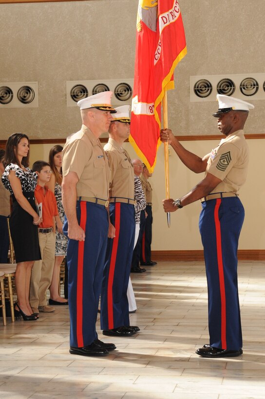 Cols. Mark J. Toal and Ted Studdard wait to receive the district colors from 8th Marine Corps District Sgt. Maj. JB Edwards during the district change of command ceremony Thursday at the Ashton Depot in Fort Worth. After three years of exceptional service, Toal relinquished command of the district to Studdard.